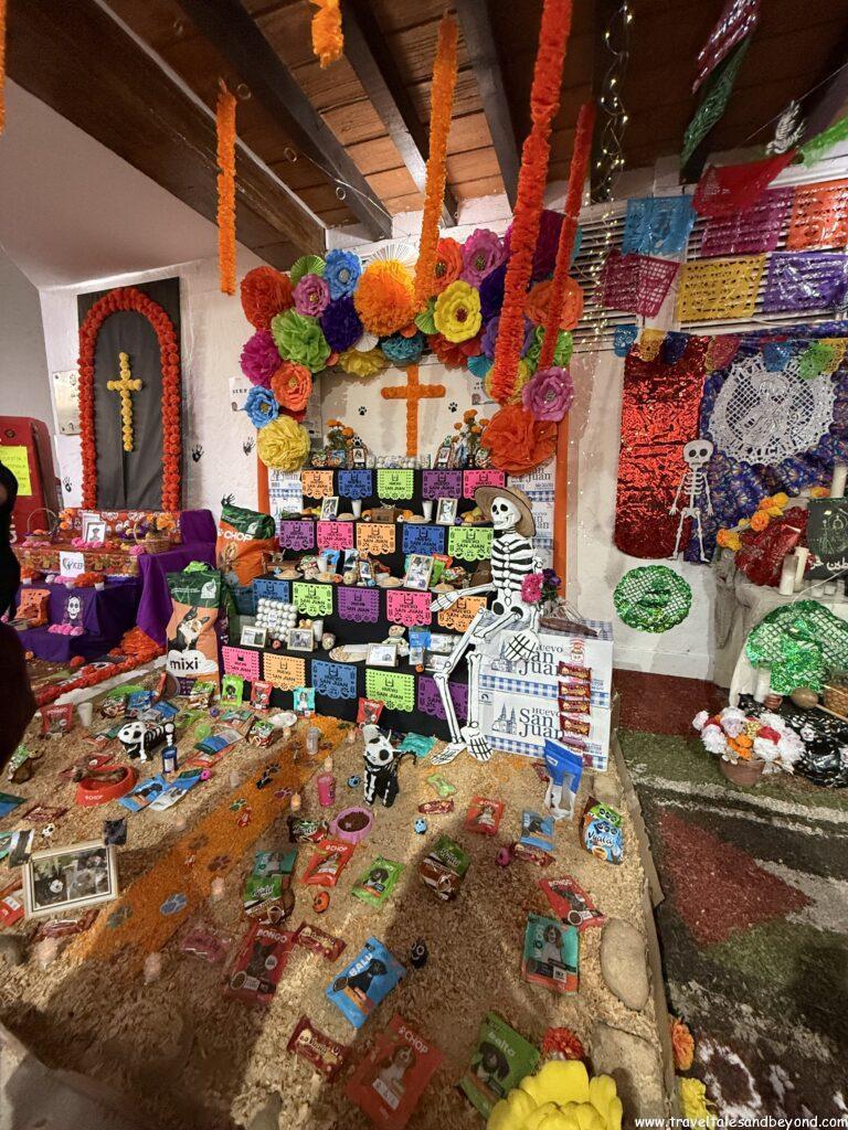 Traditional Día de los Muertos ofrenda altar with candles and marigolds