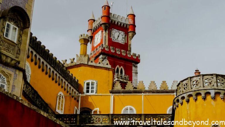 Explore the colorful architecture of Pena Palace's iconic clock tower in Sintra, Portugal.