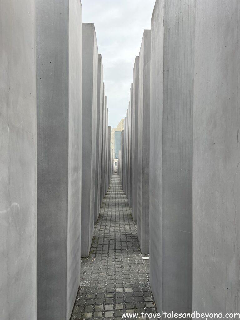 Narrow corridor between tall grey concrete stelae at the Memorial to the Murdered Jews of Europe (Holocaust Memorial), designed by Peter Eisenman, Berlin, Germany