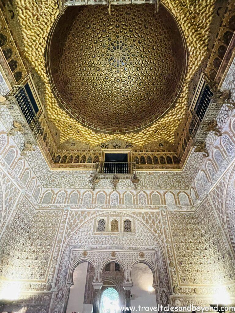 Intricate Mudéjar plasterwork and golden geometric dome ceiling inside the Royal Alcázar palace, Seville, Spain