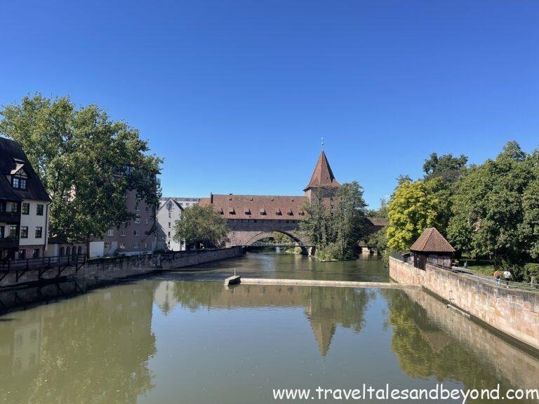 The Pegnitz River winding past Nuremberg's medieval fortification tower and half-timbered Weinstadel building